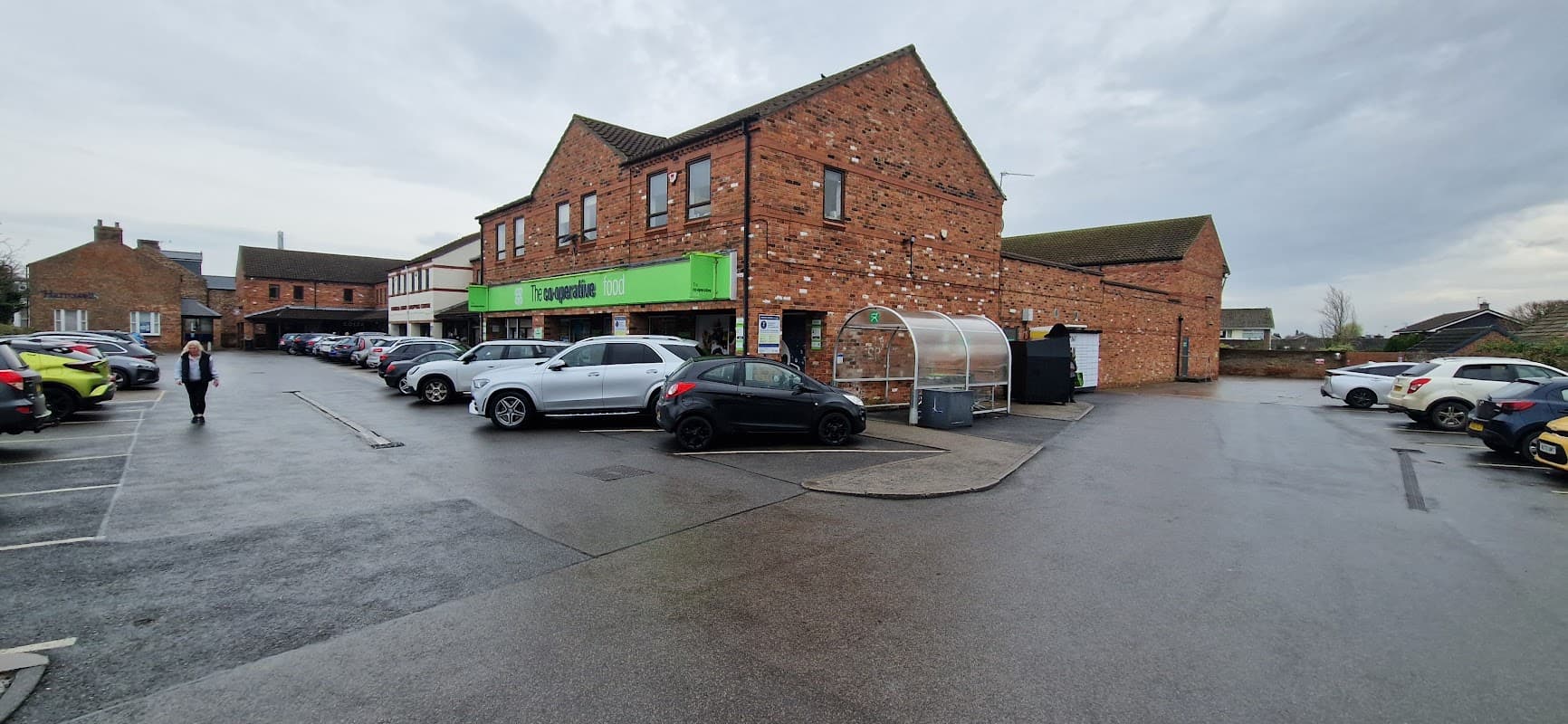 Co-op Food storefront in Haxby, Yorkshire, with parked cars and a cloudy sky overhead.