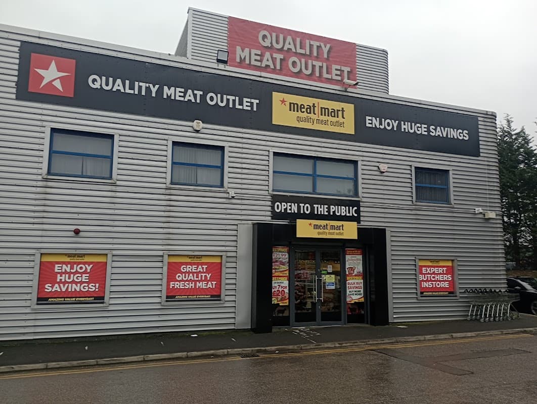 Quality Meat Outlet storefront with large signs advertising savings, open to the public, and expert butchers inside.