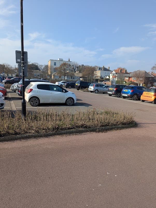 Pay & Display car park in Hornsea, Yorkshire, with various parked cars and a clear blue sky.