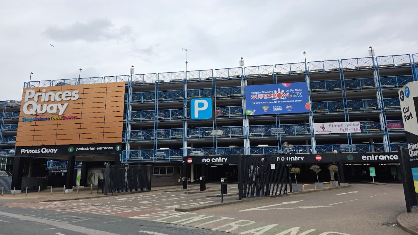 Princes Quay Car Park with blue scaffolding, signage, and entrance/exit lanes in Hull, Yorkshire.