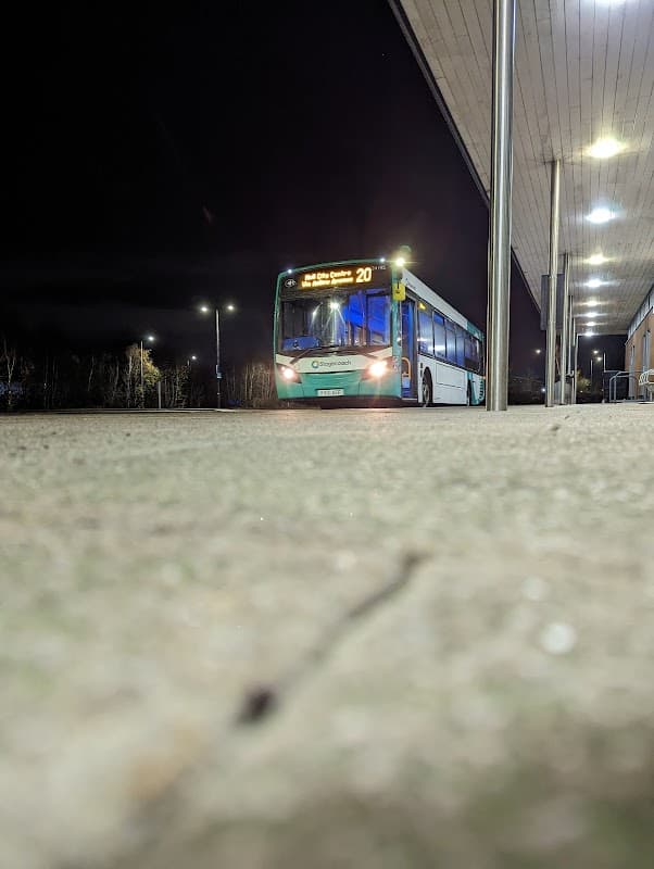 A bus at night at Priory Park Park and Ride in Hull, with lighting and a modern shelter visible.