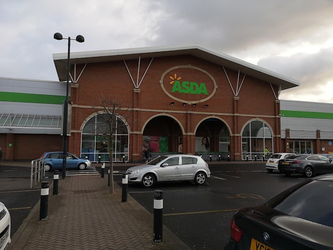 ASDA store with a large entrance, surrounded by parking spaces and cloudy skies in The Mount Retail Park, Hull.