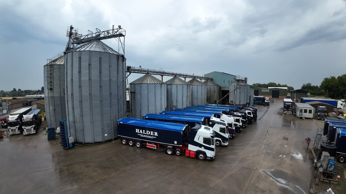 B I Halder Ltd facility with silos, trucks, and a cloudy sky in Hutton Cranswick, Yorkshire.