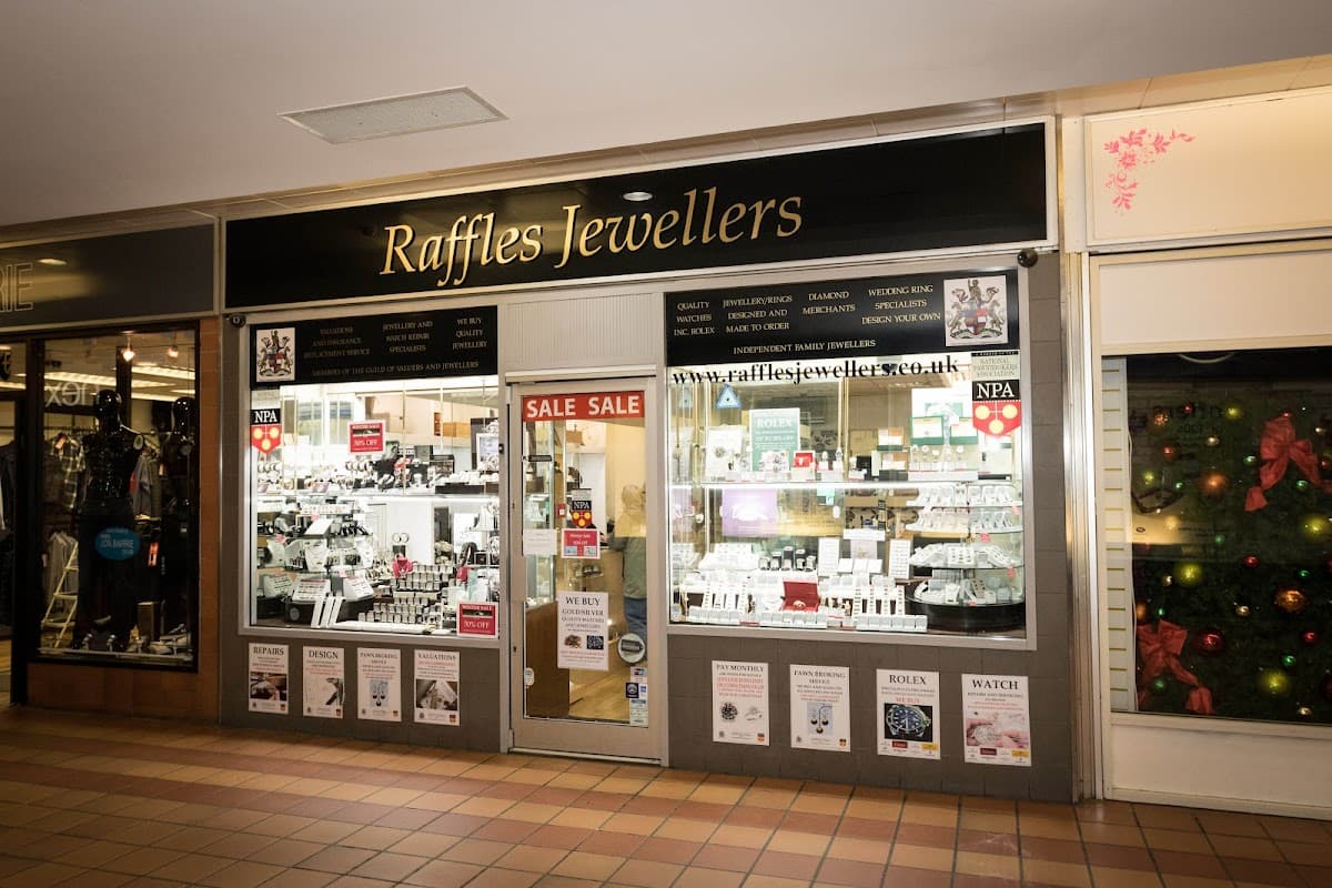 Raffles Jewellers storefront featuring displays of jewelry, a "SALE" sign, and festive decorations.