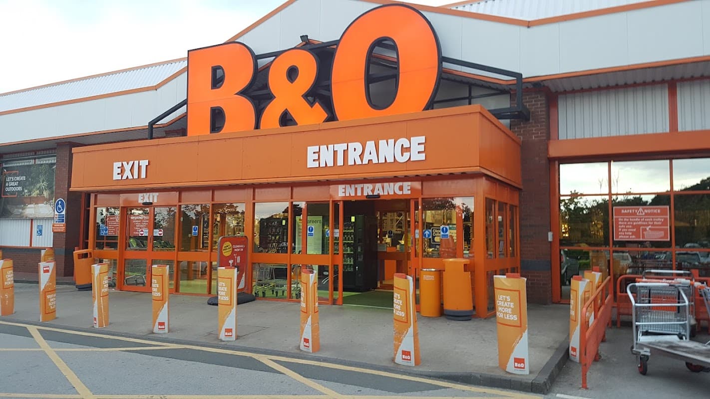 B&Q store entrance in Killingbeck, featuring large orange signage and shopping carts outside.
