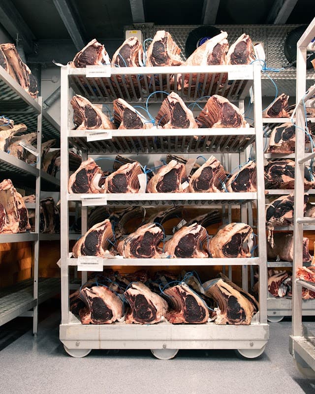 Shelves filled with aged beef cuts, neatly arranged in a meat storage area at R&J Yorkshire's Finest Farmers & Butchers.