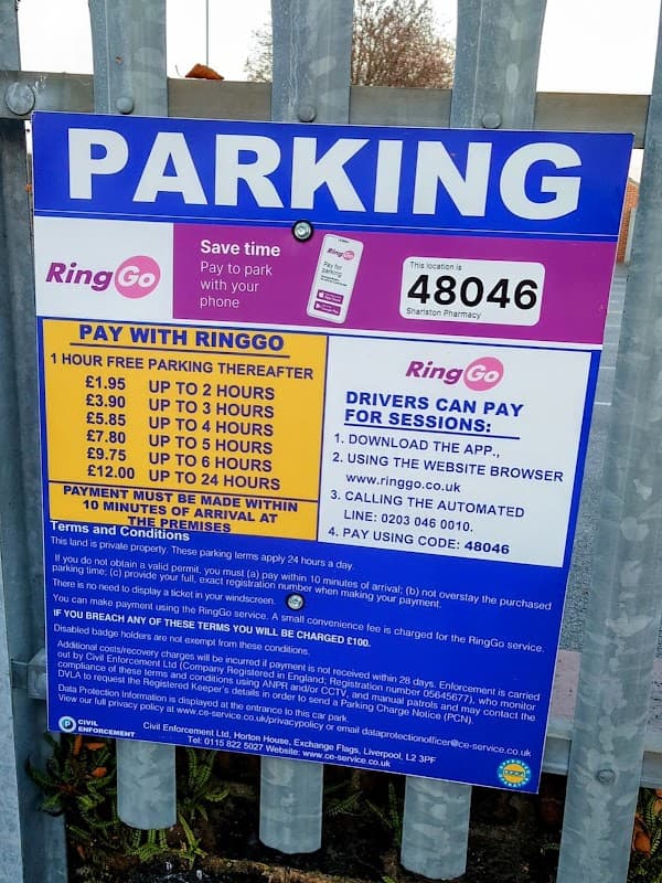 Parking sign detailing Pay & Display rates and payment options at Sharlston Pharmacy Car Park in Kirkthorpe, Yorkshire.
