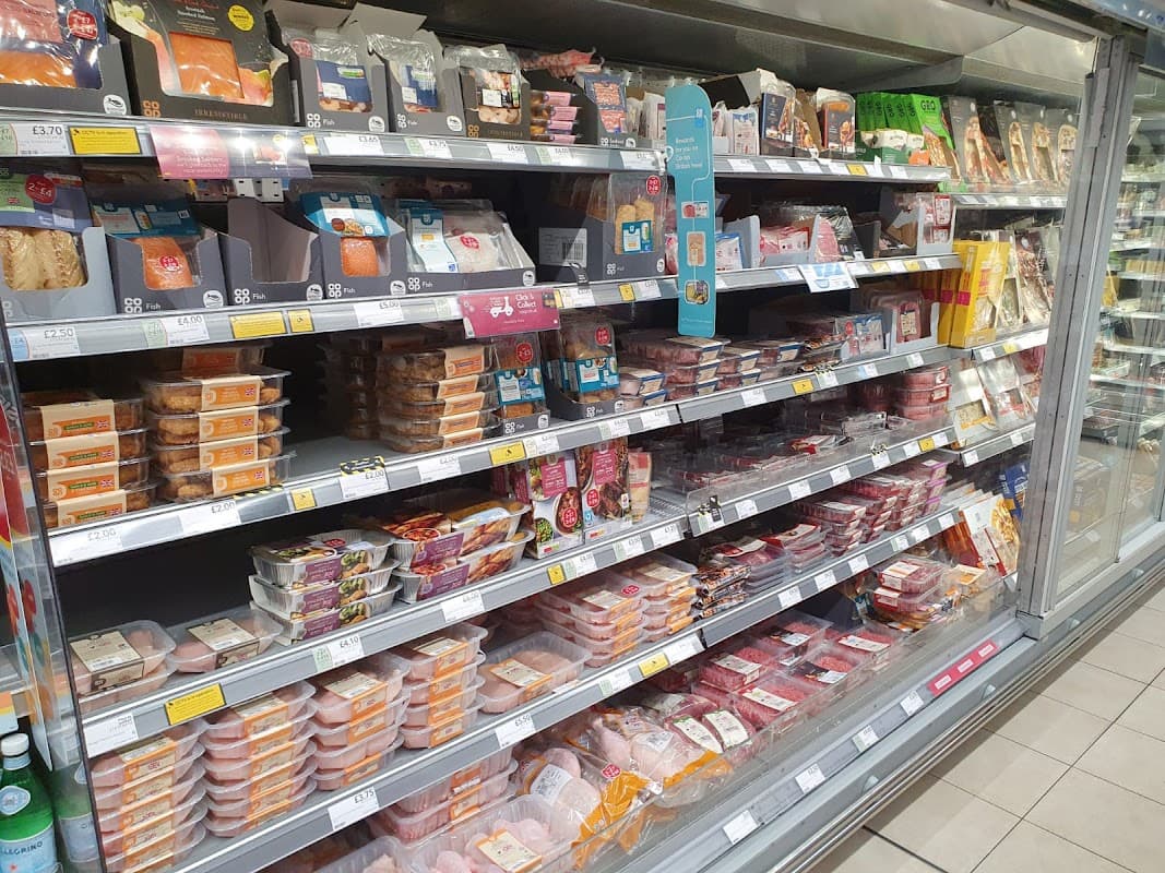 Chilled food aisle at Co-op Food, featuring a variety of packaged meats and ready meals on display.