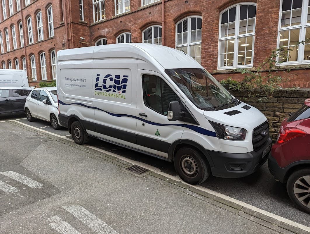 JustPark Pay & Display sign in Leeds, with parked vehicles and a white van marked "LCM Environmental."