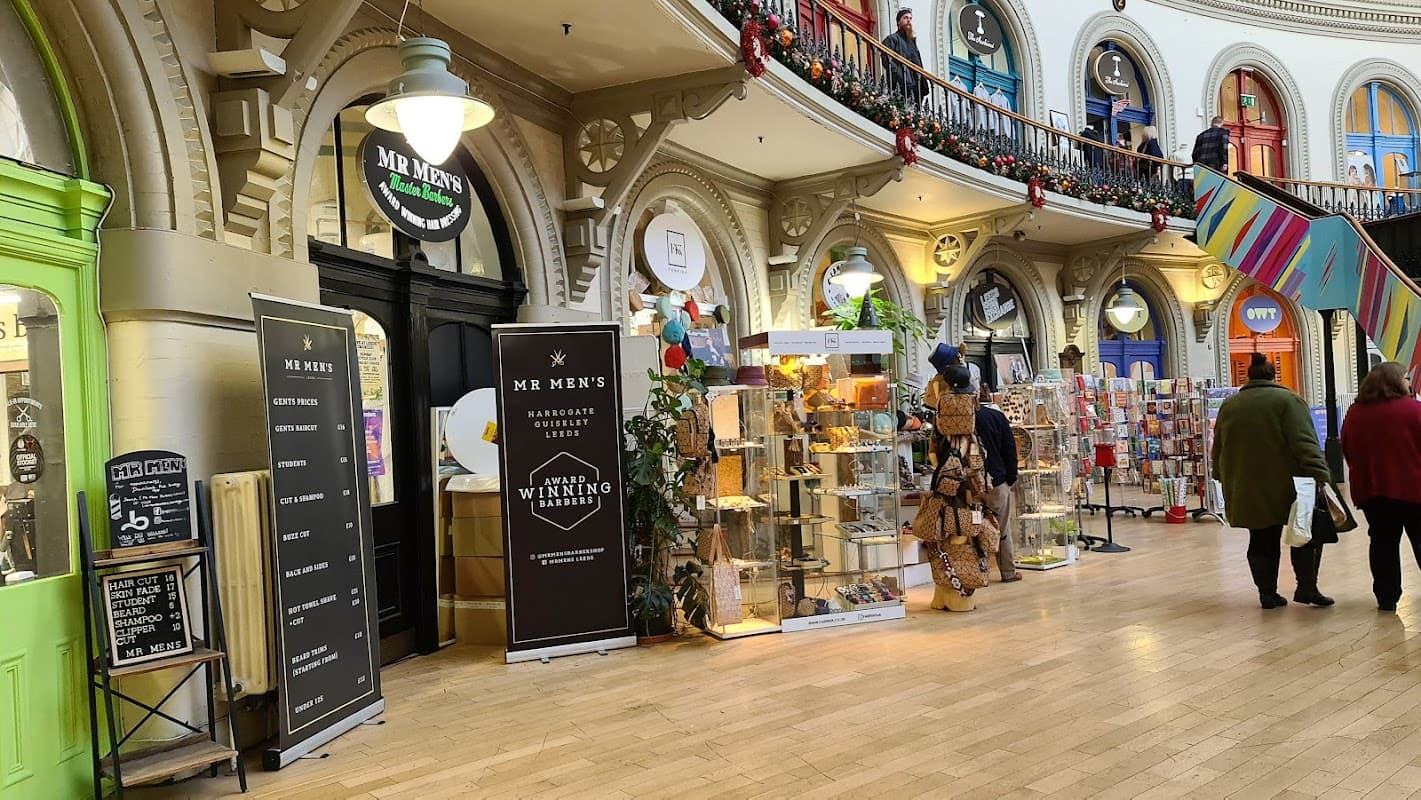 Interior view of Leeds Corn Exchange, featuring shops, decorative arches, and festive decorations.