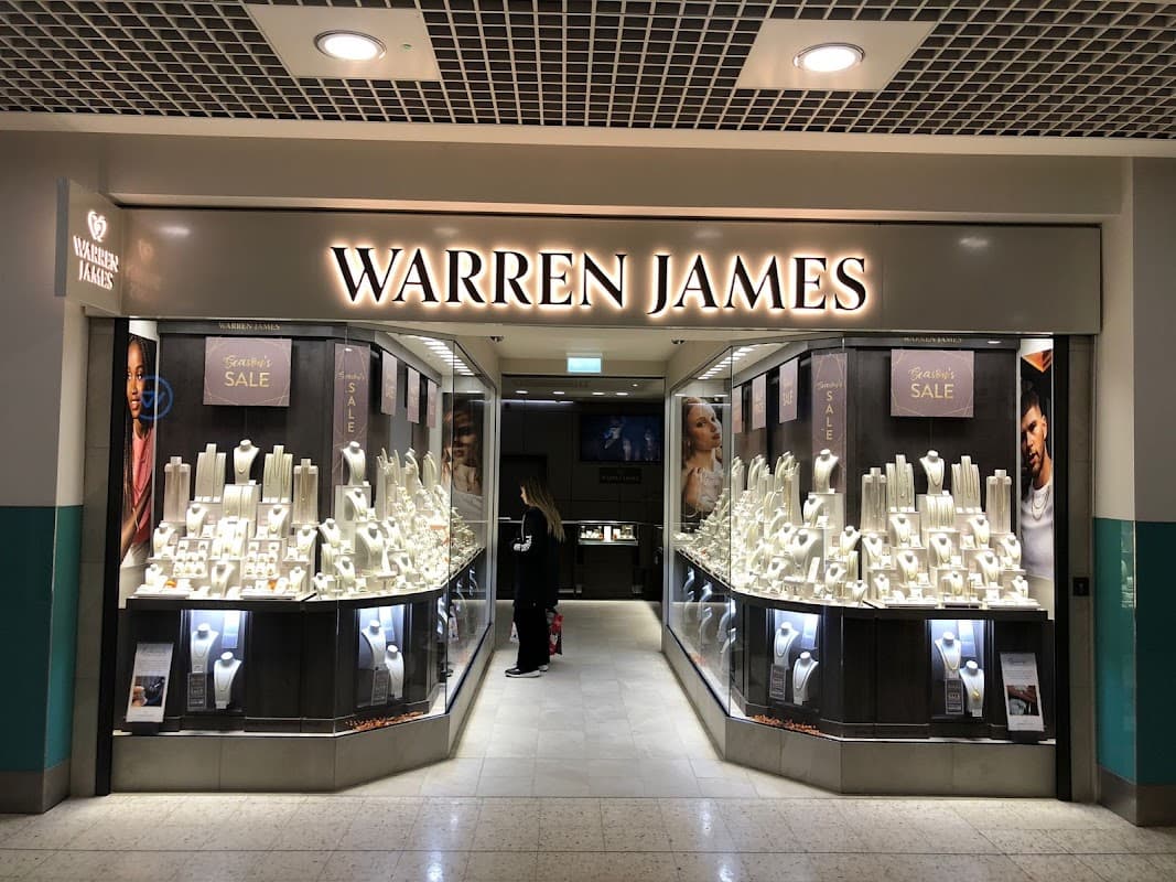 Warren James Jewellers storefront featuring elegant displays of jewelry and a "Sale" sign in Leeds, Yorkshire.