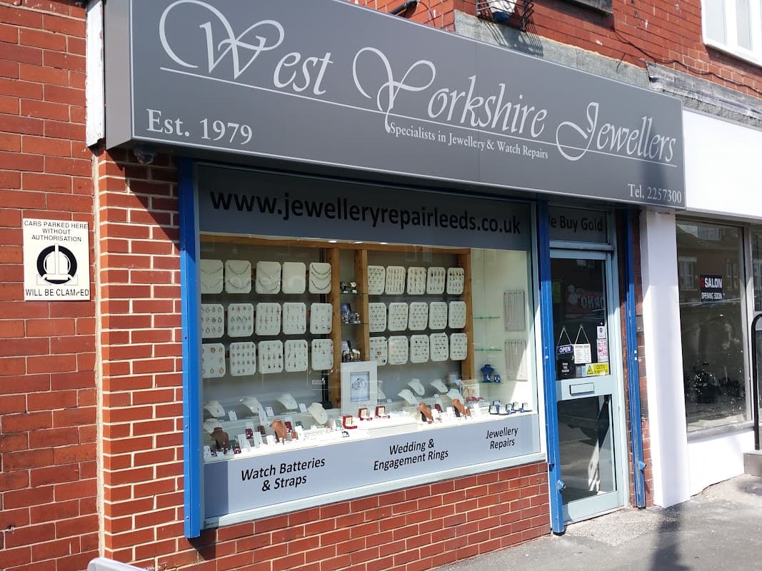 Storefront of West Yorkshire Jewellers with display cases showcasing rings, watches, and jewelry repair services.