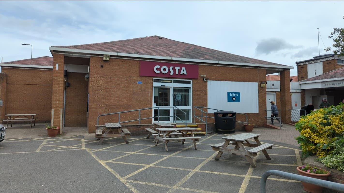 Costa Coffee shop with a brick exterior, outdoor seating, and accessible entrance in Leeming Bar, Yorkshire.