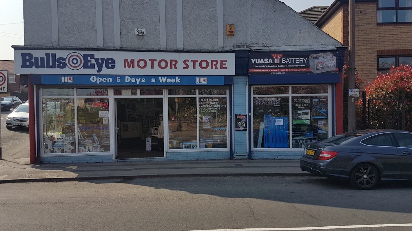 BullsEye Motorist Centre storefront with large windows, signage, and an "Open 6 Days a Week" banner.