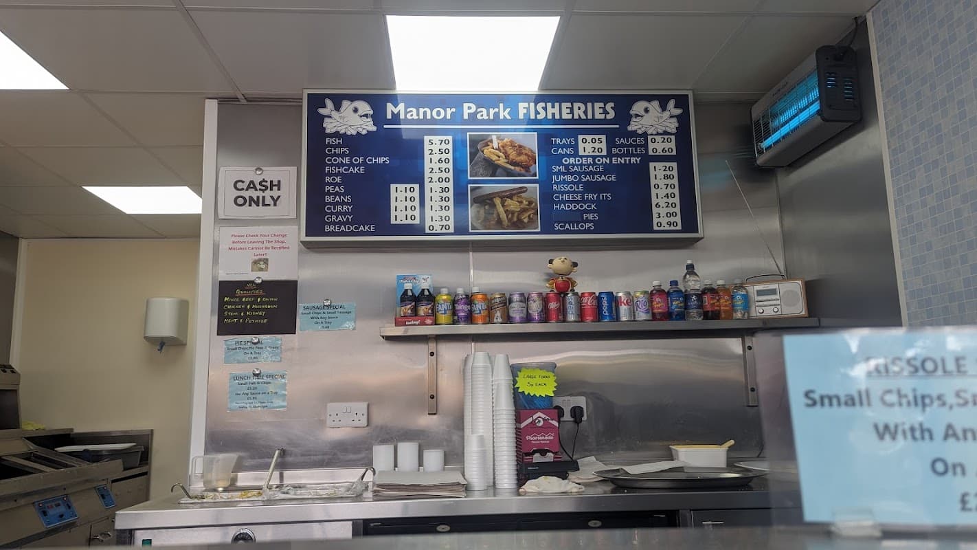 Menu board displaying fish and chip options, prices, and a cash-only sign at Manor Park Fisheries.