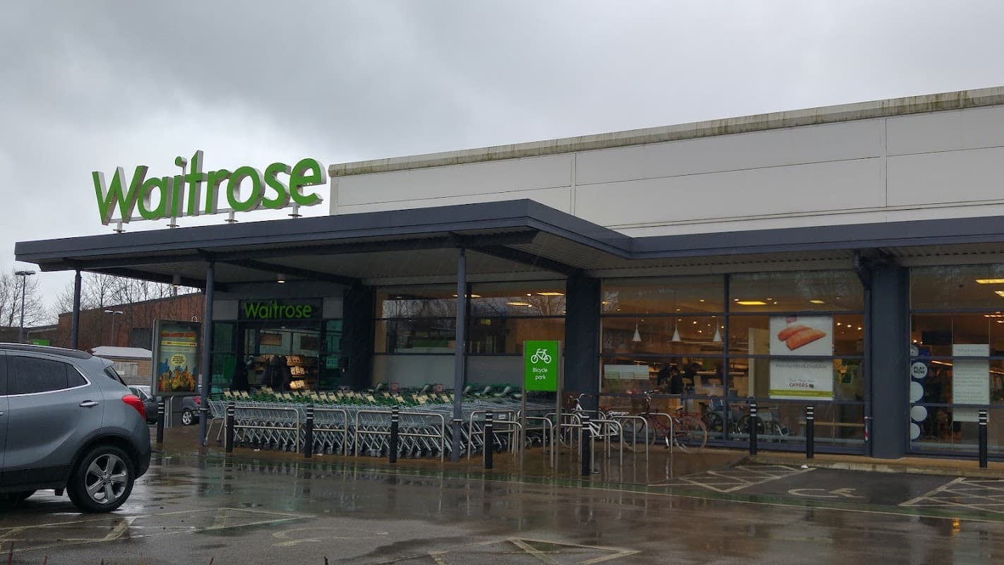 Waitrose & Partners store in Meanwood, Yorkshire, featuring green signage and shopping carts outside.