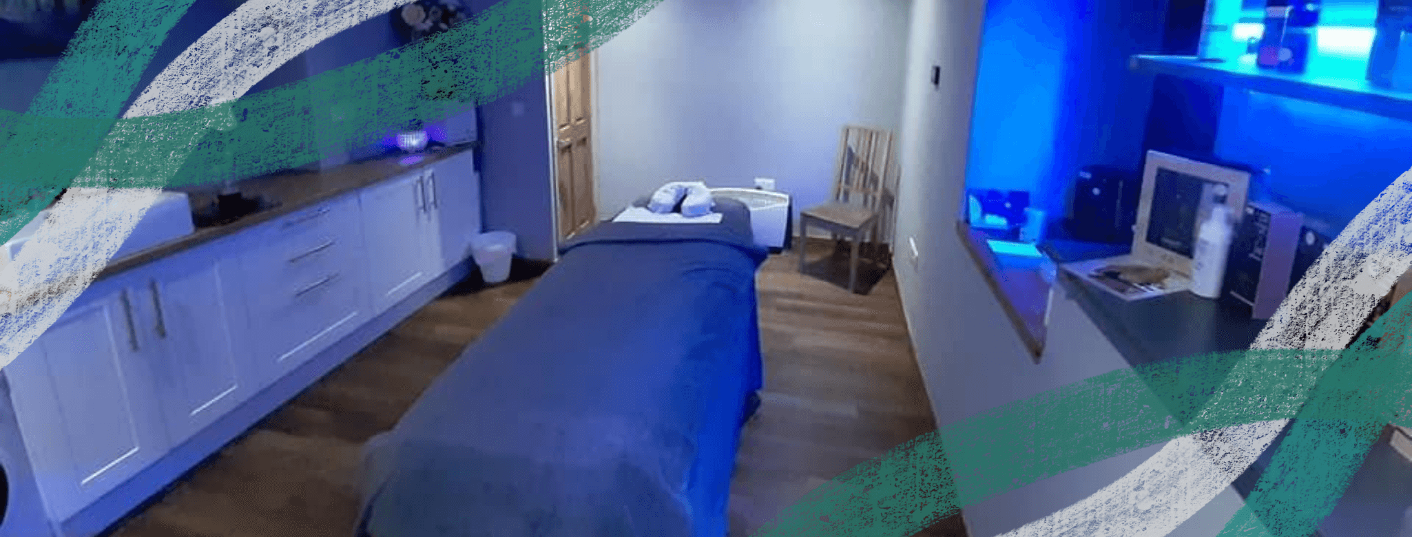 Serene therapy room with a massage table, soft lighting, and calming decor in Goodwood Beauty & Holistic Therapies.