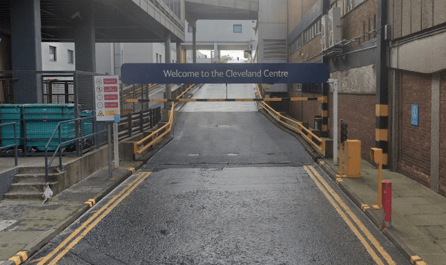 Welcome sign for Cleveland Centre car park, with a sloped entrance and surrounding buildings in Middlesbrough.