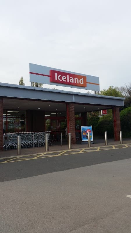 Iceland supermarket entrance with shopping carts and a clear sign, located in Monk Bretton, Yorkshire.