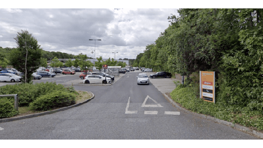 Parking lot entrance with cars, greenery, and a sign for "YourParkingSpace" in Moortown, Yorkshire.