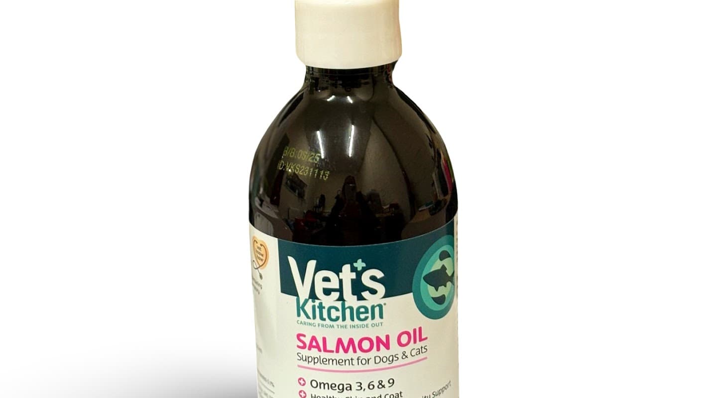 Bottle of Vet's Kitchen Salmon Oil supplement for dogs and cats, labeled with Omega 3, 6, and 9 information.