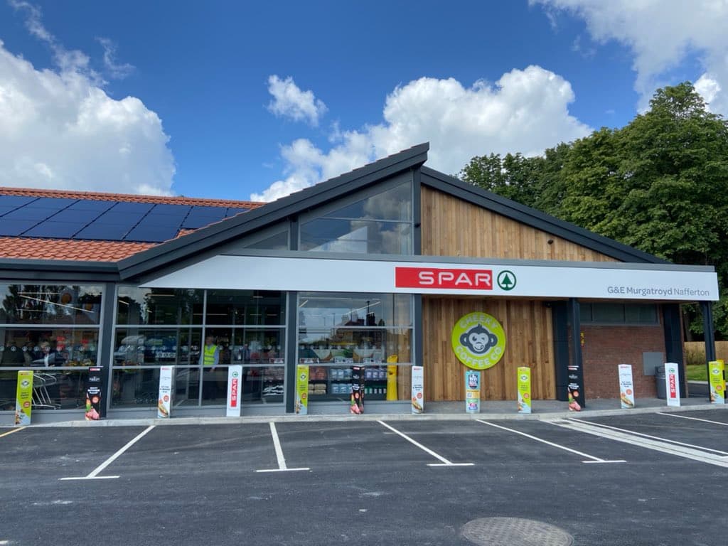 Spar grocery store in Nafferton, Yorkshire, featuring a modern design, large windows, and a parking area with signage.