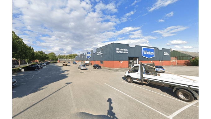 Pay & Display parking area in Neepsend, Yorkshire, with several parked cars and retail buildings in the background.