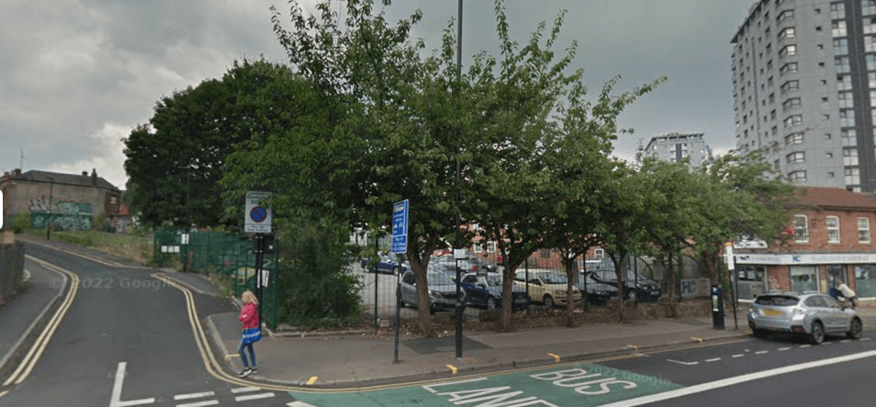 Pay & Display parking area in Nether Edge, Yorkshire, with trees, signage, and nearby buildings.