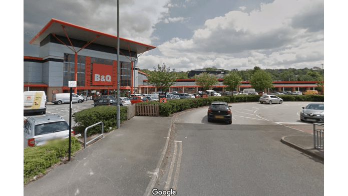B&Q store with a large parking area, trees, and cloudy sky in Nether Edge, Yorkshire.