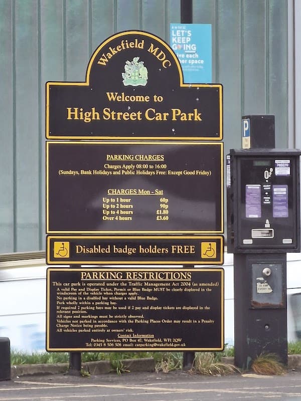 Signage for High Street Car Park with parking charges and restrictions in Normanton, Yorkshire.