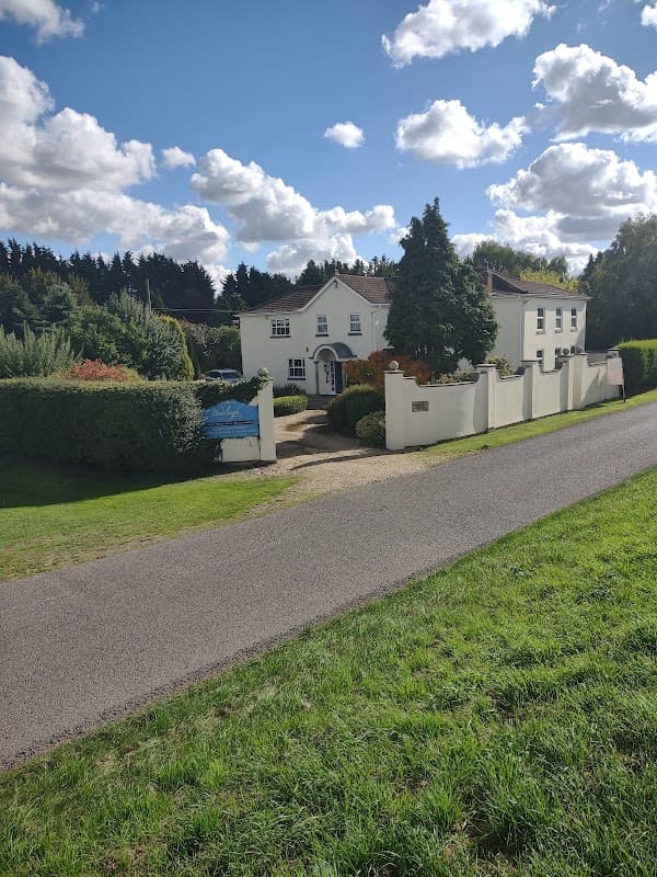 White house with a welcoming entrance, surrounded by greenery and a well-maintained garden in North Frodingham.