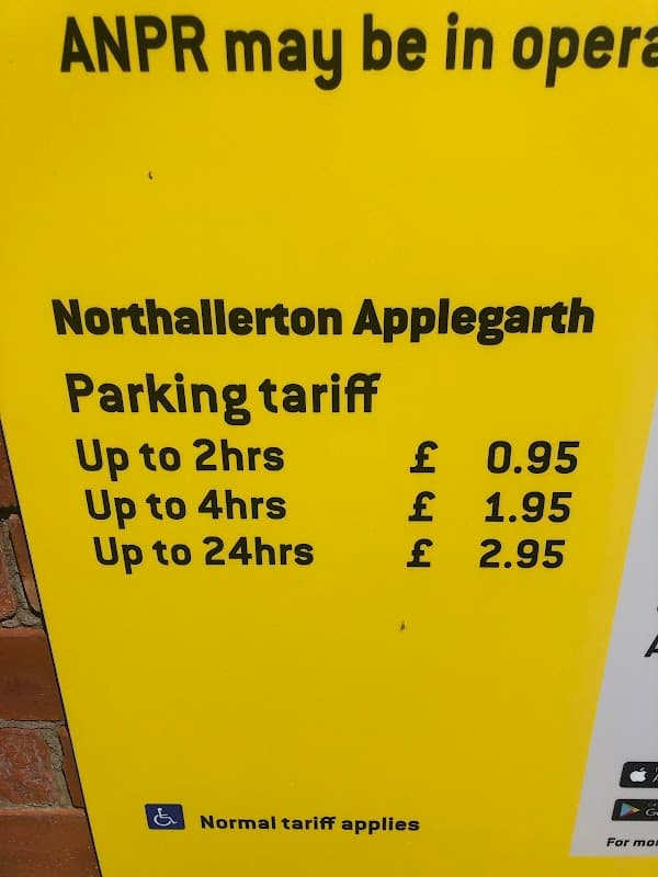 Bright yellow parking sign listing tariffs for Northallerton Applegarth: £0.95 for up to 2hrs, £1.95 for 4hrs, £2.95 for 24hrs.