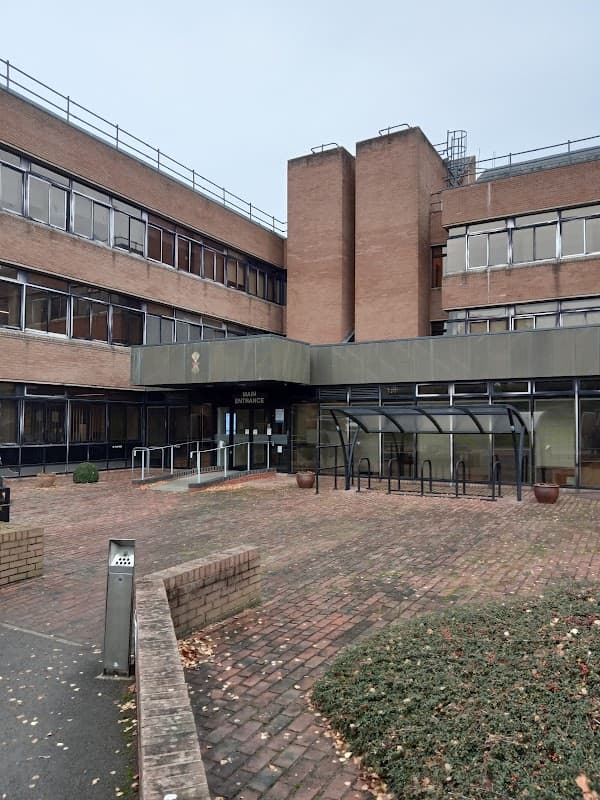 Modern brick building with large windows, entrance canopy, and landscaped brick pathway in Old Malton, Yorkshire.