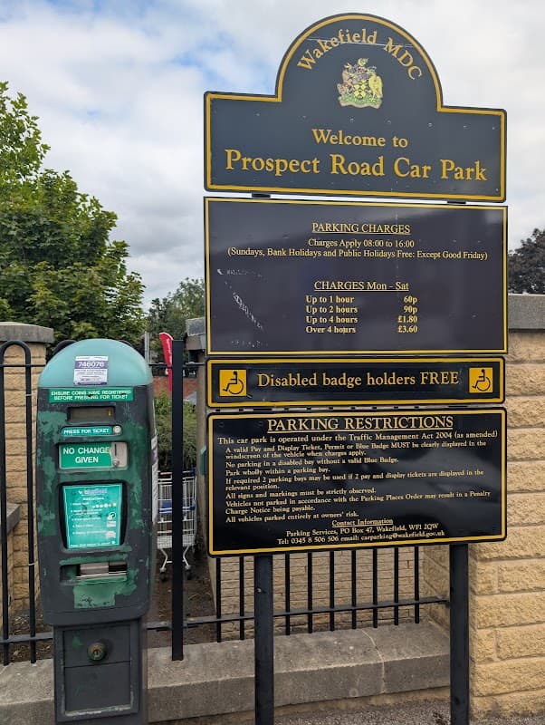 Welcome sign for Prospect Road Car Park with parking charges, restrictions, and a Pay & Display machine nearby.