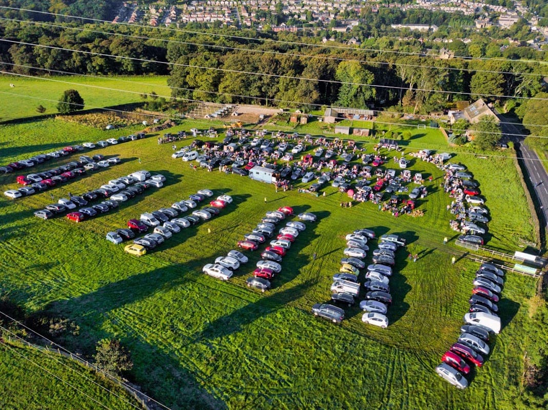 Aerial view of Jawbone Carboot in Oughtibridge, featuring rows of parked cars on a grassy field.