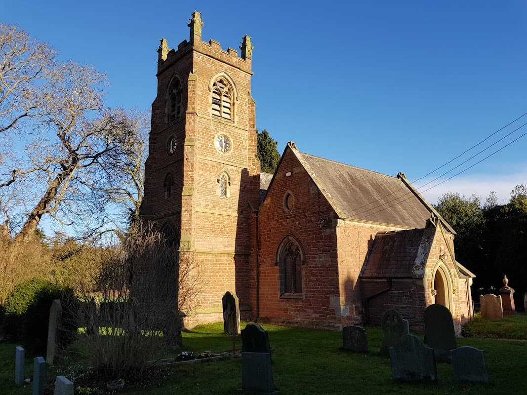 Low Dinsdale Manor features a historic church with a tall clock tower, surrounded by gravestones and greenery.