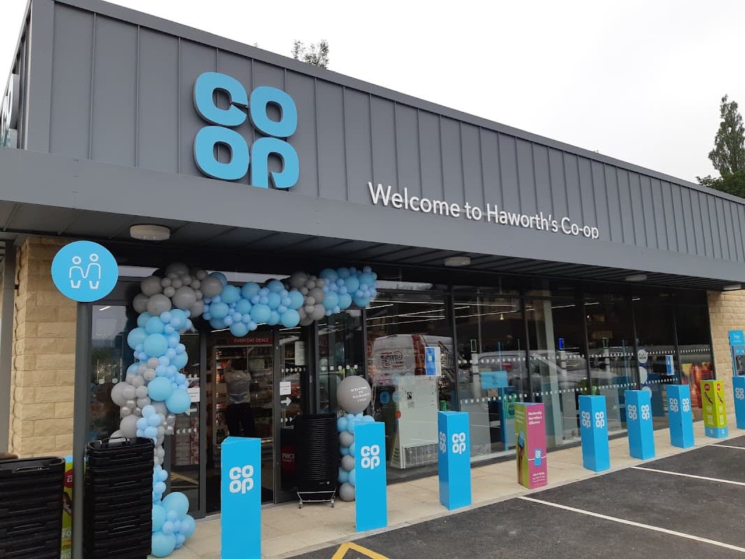 Welcome to Haworth's Co-op, featuring a modern entrance with blue and white balloon decorations and clear signage.