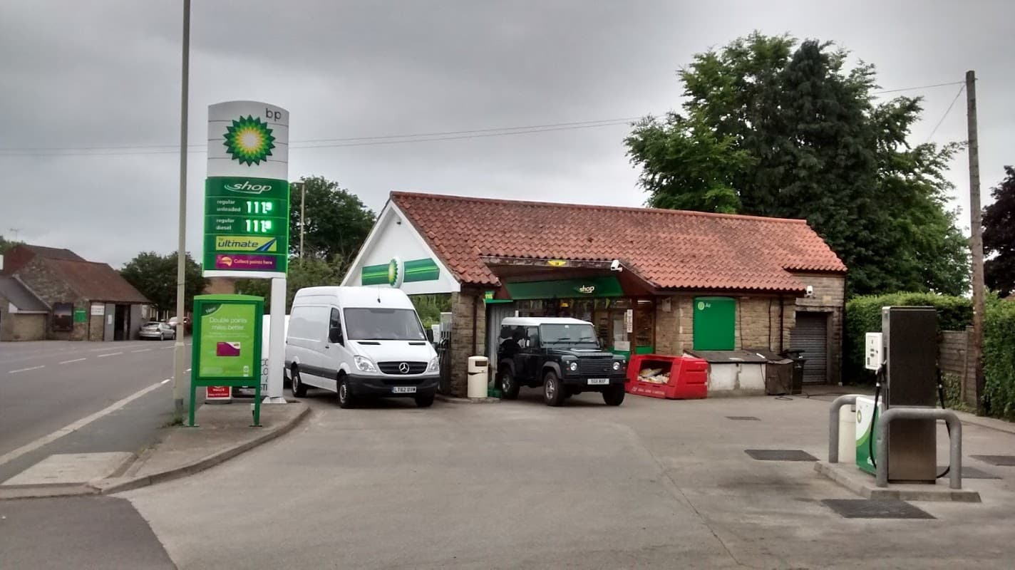 BP car wash in Pickering, Yorkshire, featuring a shop, two vehicles, and a fuel price display under a cloudy sky.