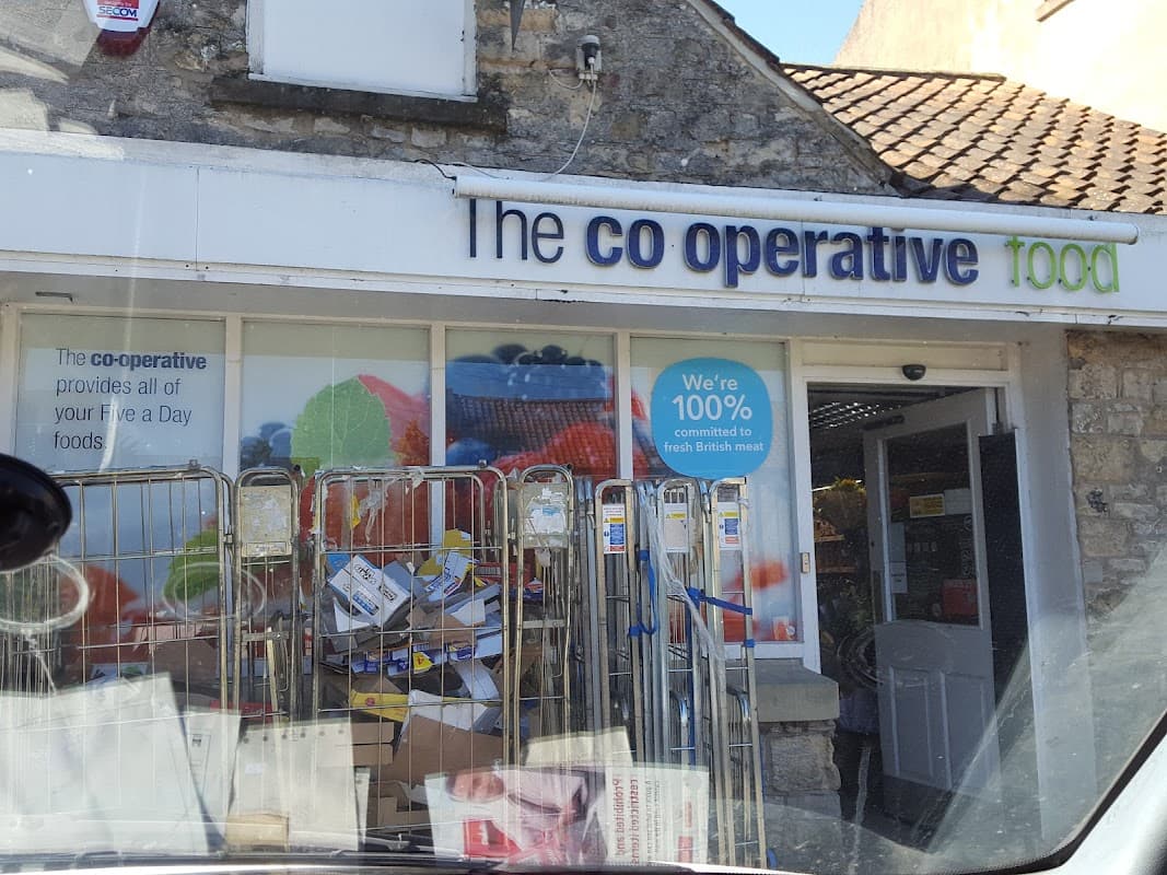 Co-op Food storefront with colorful signage, shopping carts, and boxes outside in Pickering, Yorkshire.
