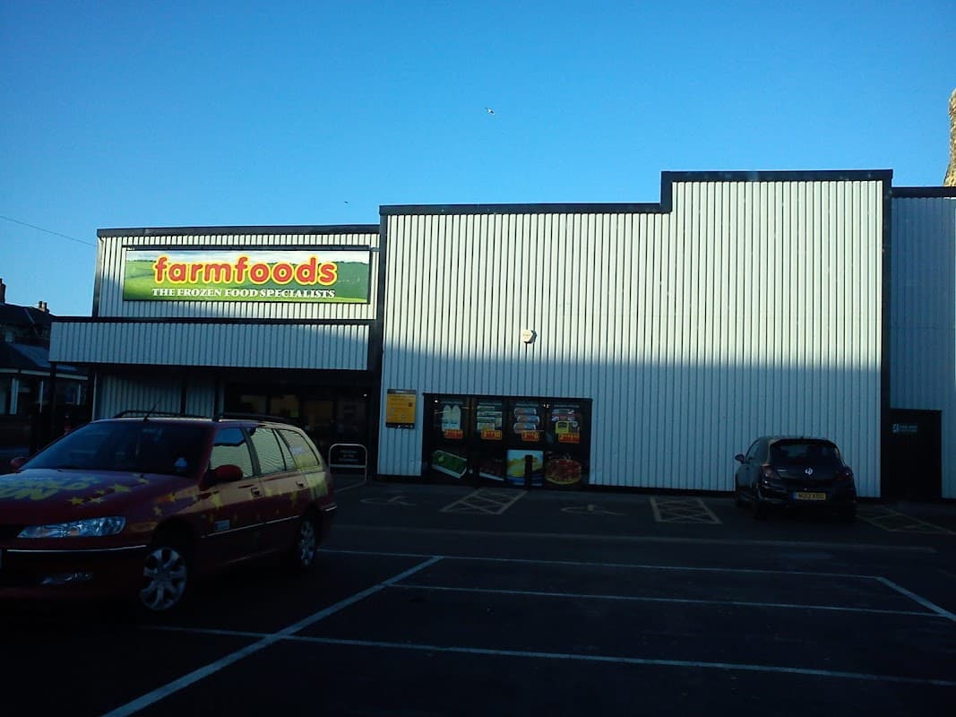 Farmfoods Ltd shop exterior in Redcar, featuring a sign and large windows, with parked cars in front.