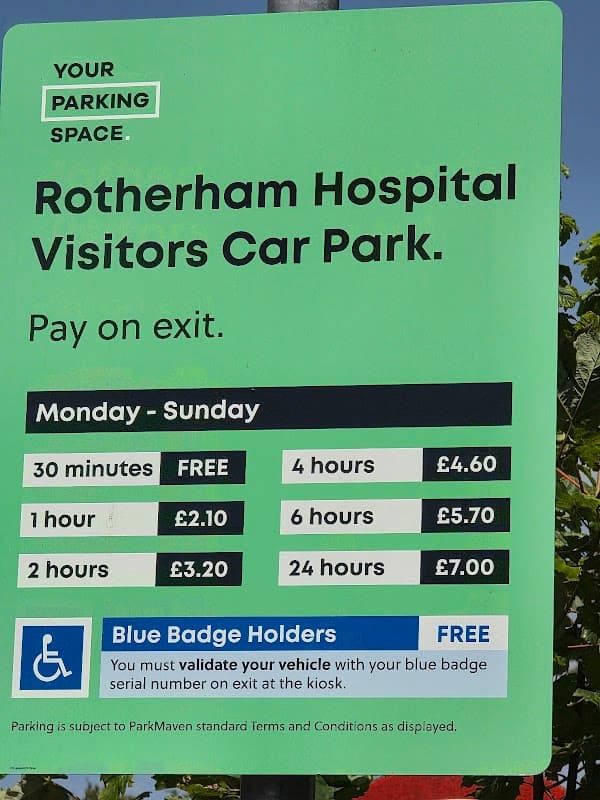 Rotherham Hospital Visitors Car Park sign detailing parking fees and times, with accessibility information for Blue Badge holders.