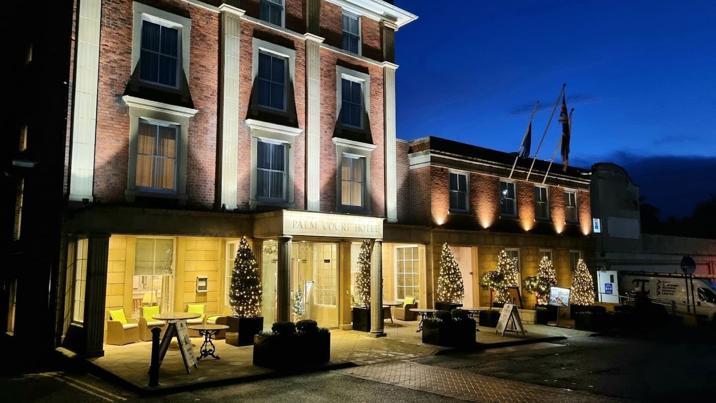 Falconers Road Car Park at night, featuring illuminated Palm Court Hotel entrance and festive decorations.