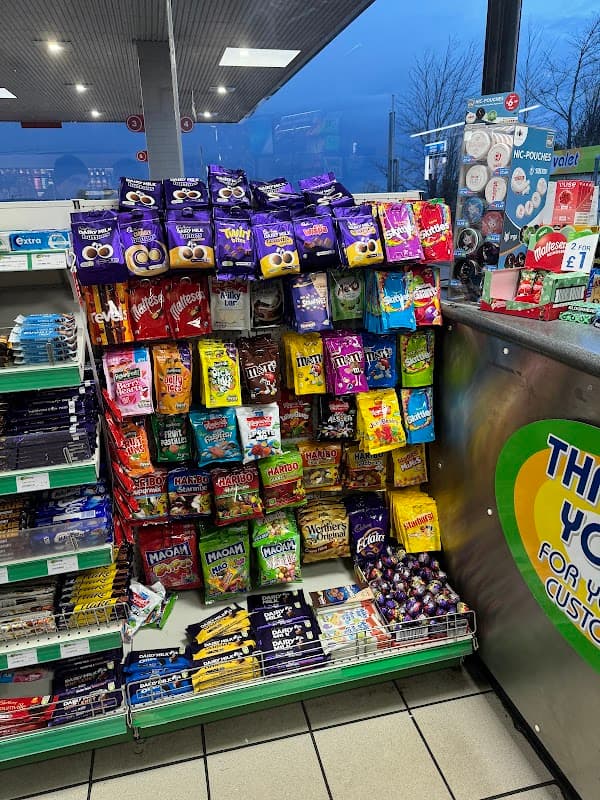 Colorful display of snacks and sweets in a convenience store, with various brands and types prominently arranged.