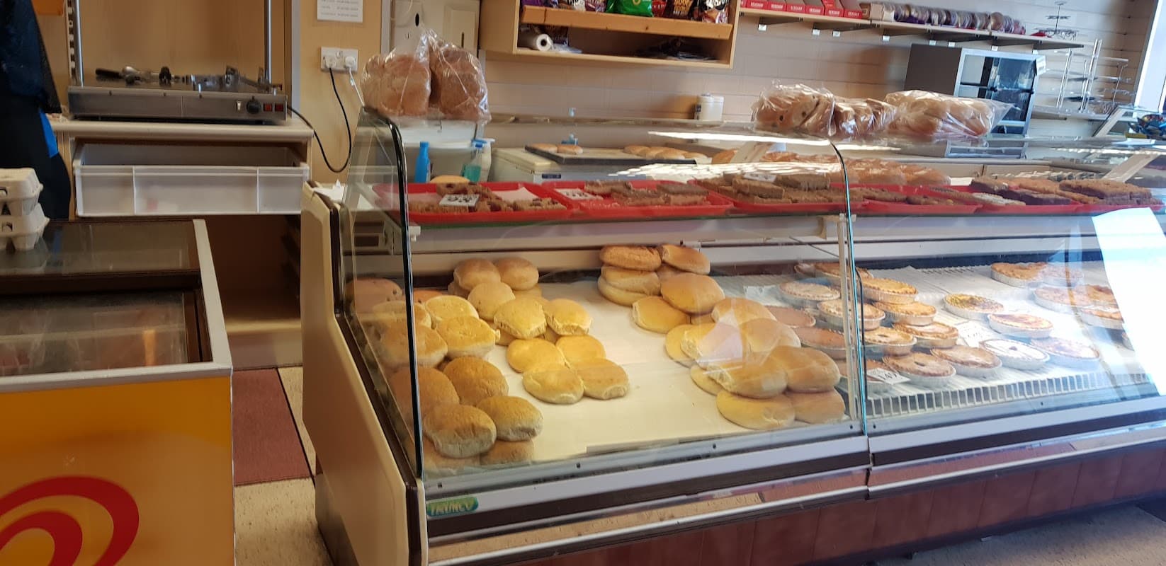 Display case filled with fresh bread rolls and pastries at Barkers The Bakers in Sheffield, Yorkshire.