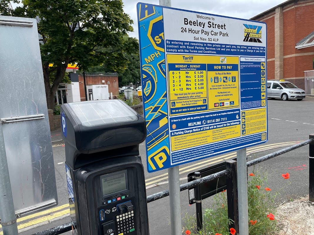 Beeley Street Car Park sign with parking fees, payment instructions, and a pay station in Sheffield, Yorkshire.