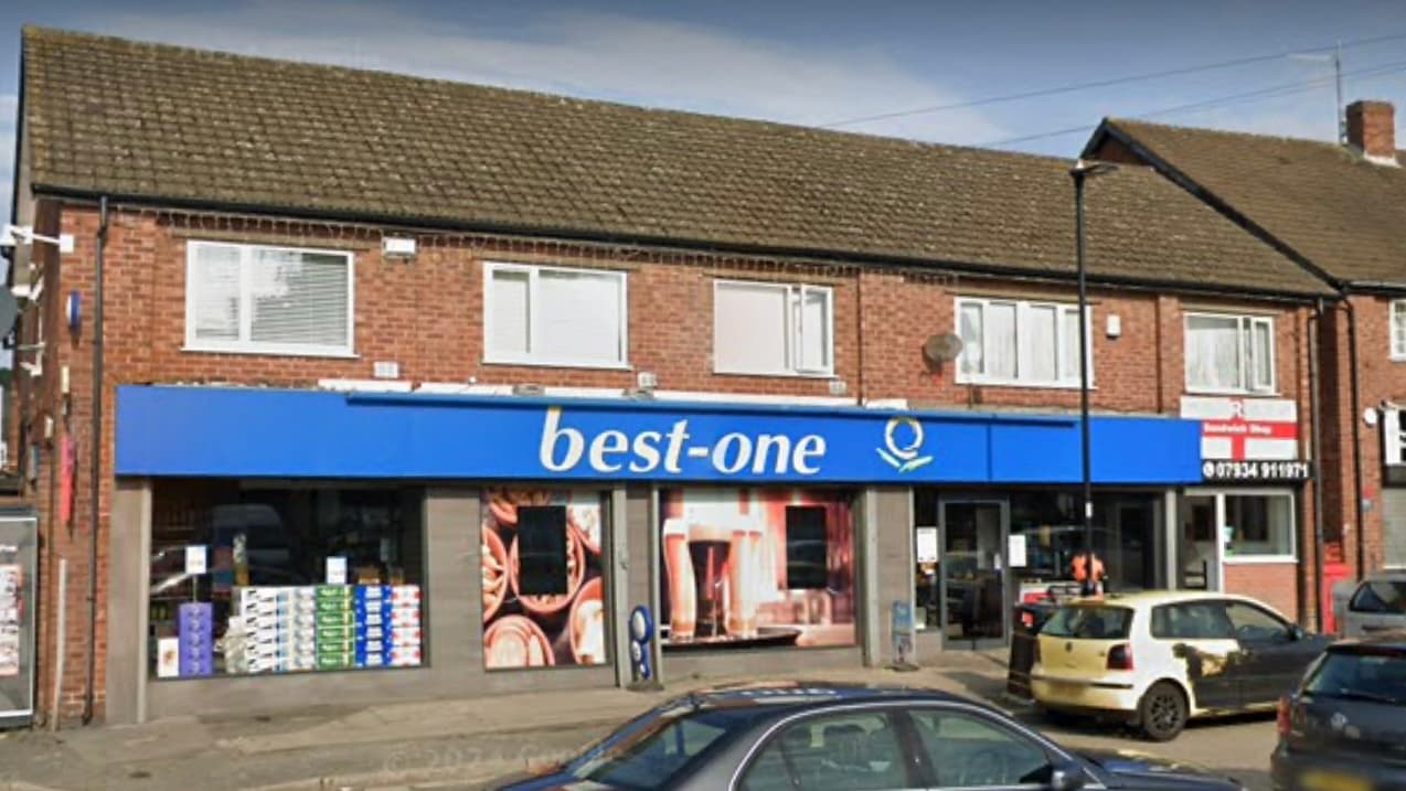 Blue storefront with "best-one" sign, displaying beverages, located in a brick building in Sheffield, Yorkshire.