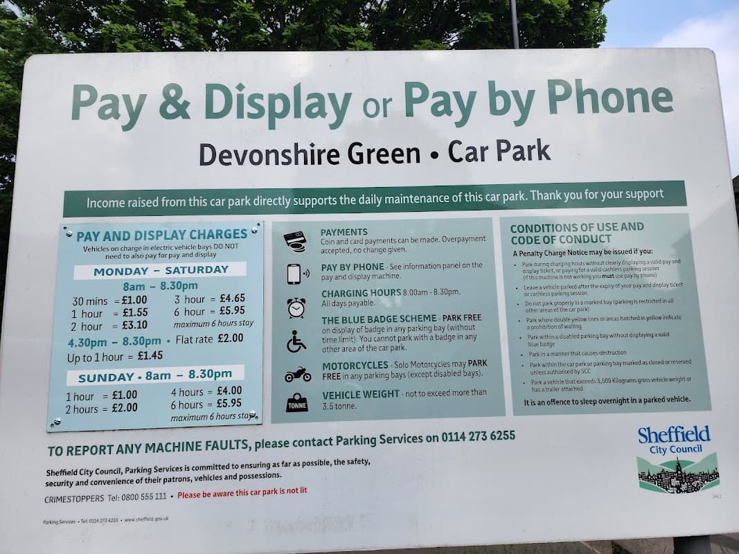 Pay & Display sign detailing charges, hours, and payment options for Devonshire Green Car Park in Sheffield.