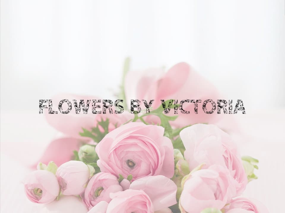 Delicate pink flowers arranged beautifully with the text "Flowers By Victoria" overlaying the composition.