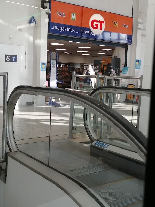 GT Bookshop in Sheffield, featuring an escalator and a bright storefront with signage for magazines and newspapers.