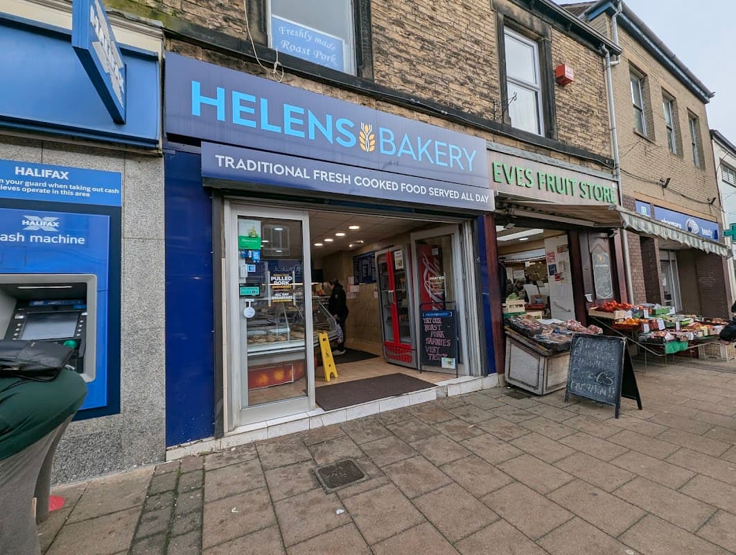 Helens Bakery storefront with blue signage, fresh food display, and a nearby fruit store in Sheffield, Yorkshire.